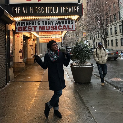 Ian Espiritu posing in front of a theater